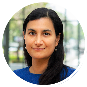 a woman with dark hair wearing earrings